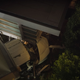 A photo of a delivery truck crashed into the side of a house.